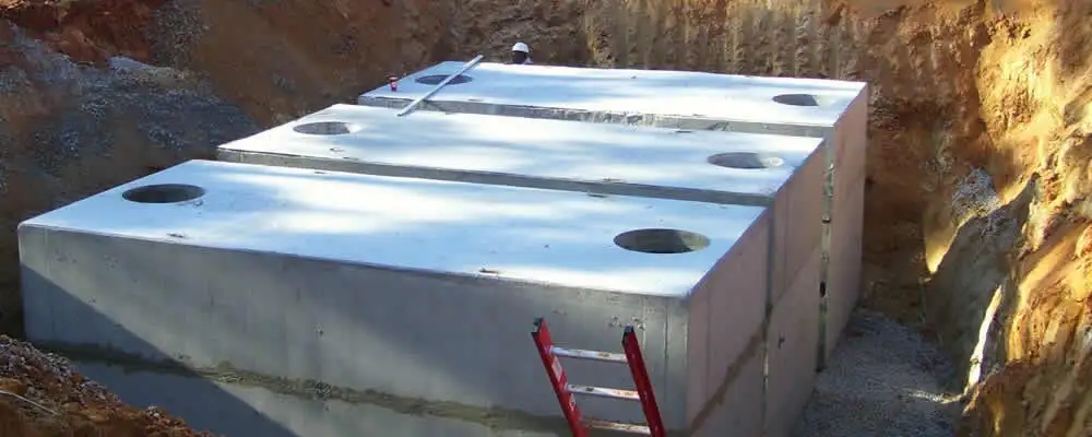 Septic tank installation site with a newly placed concrete tank in Grand Rapids, MI
